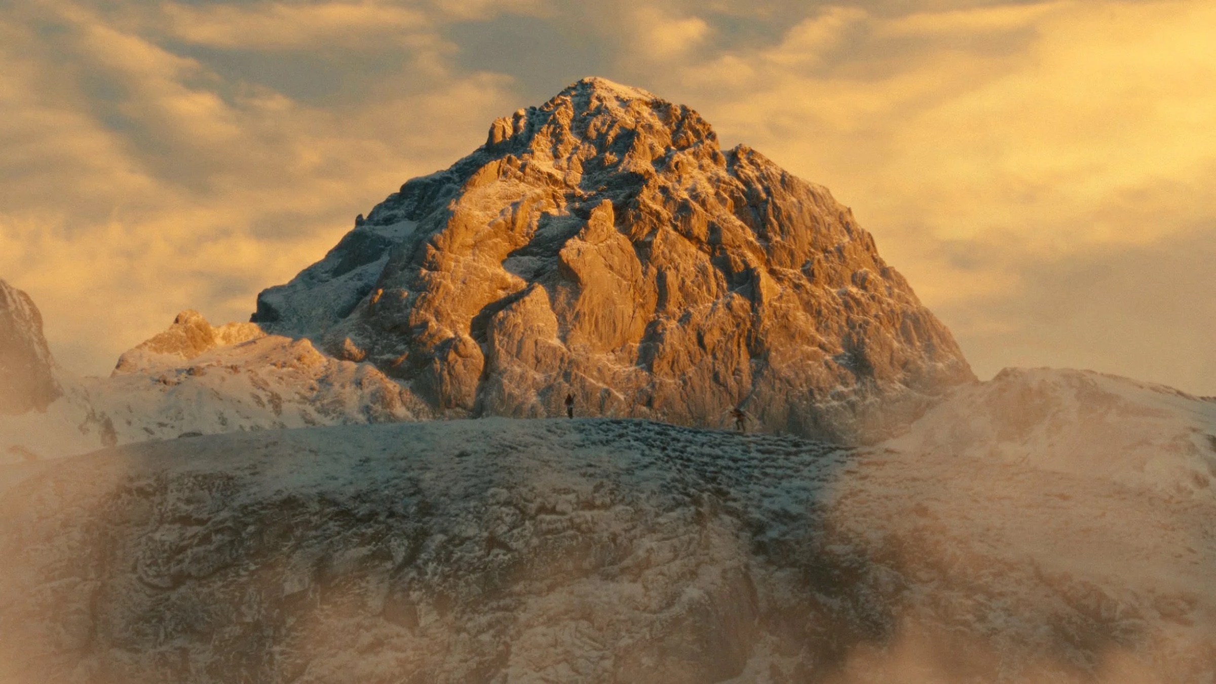 A snow-covered mountain illuminated by warm light