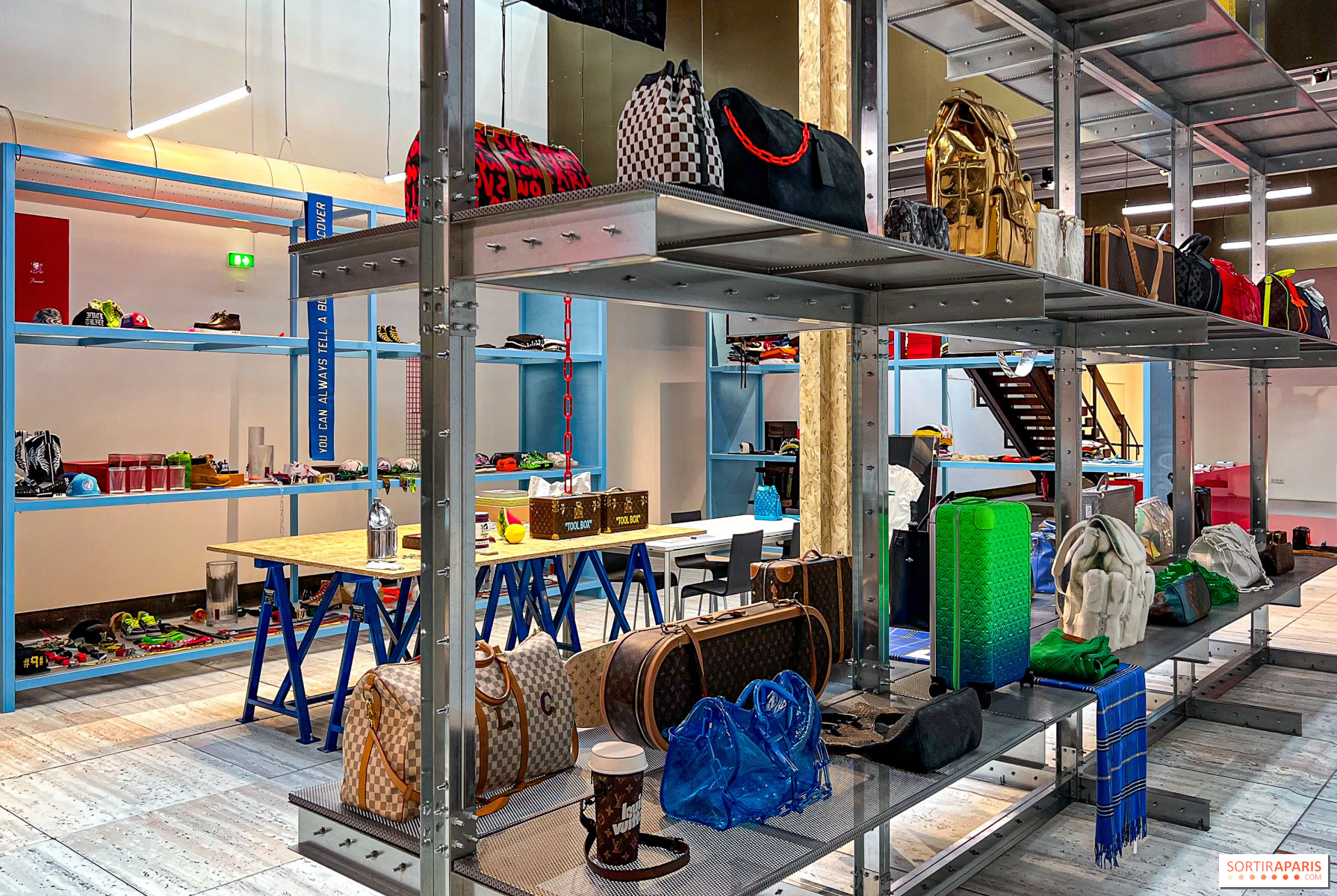 Fashion pieces displayed on industrial shelving at a Virgil Abloh exhibition